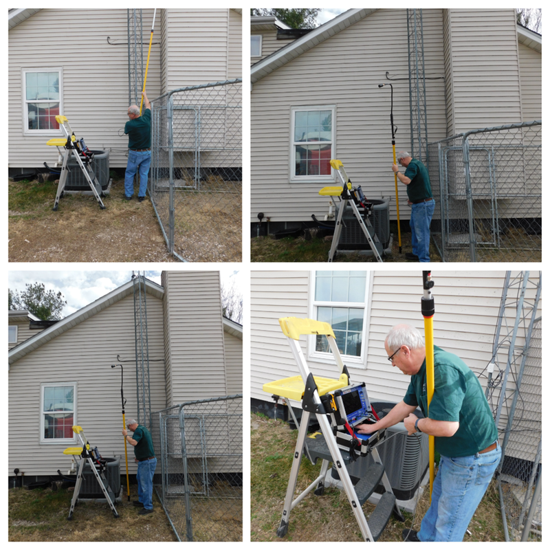 A man is using a Chim-Scan® Enviro Camera on an adjustable telescoping pole while viewing a monitor..